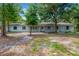 Charming single-story home featuring a light-colored brick facade and mature trees at 605 Ronele Dr, Brandon, FL 33511
