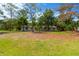 Single-story home with a spacious front lawn surrounded by mature trees and natural beauty at 605 Ronele Dr, Brandon, FL 33511
