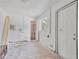 Bright utility room featuring a utility sink, shelving, and window, offering natural light, and access to the exterior at 605 Ronele Dr, Brandon, FL 33511