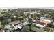Beautiful aerial view of residential neighborhood with lush trees, water access, and homes with refreshing pools at 648 Geneva Pl, Tampa, FL 33606