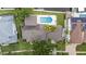 Top-down aerial showing a private pool, tropical trees, and a well-maintained roof at 648 Geneva Pl, Tampa, FL 33606