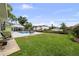 Expansive backyard featuring a sparkling pool, waterfront access, and lush landscaping, perfect for outdoor enjoyment at 648 Geneva Pl, Tampa, FL 33606