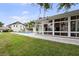 Spacious backyard featuring a pool, patio, and sunroom, with waterfront views enhancing outdoor enjoyment at 648 Geneva Pl, Tampa, FL 33606