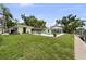 Spacious backyard featuring a refreshing pool, lush green lawn, and direct access to the waterway at 648 Geneva Pl, Tampa, FL 33606