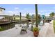 Picturesque dock featuring a boat lift and scenic views of the serene waterfront and neighborhood homes at 648 Geneva Pl, Tampa, FL 33606