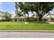 Charming single-story home with a lush green lawn and mature landscaping at 648 Geneva Pl, Tampa, FL 33606