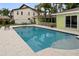 Beautiful pool with tile surround, set amongst tropical landscaping and a covered patio at 648 Geneva Pl, Tampa, FL 33606