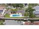 Aerial view of a beautiful waterfront home with a private pool and boat dock on a canal at 648 Geneva Pl, Tampa, FL 33606