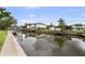 Waterfront view of the channel and docks in front of the homes, with beautiful reflections on the water at 648 Geneva Pl, Tampa, FL 33606