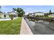 Stunning waterfront view with boats docked, showcasing the home's backyard, pool, and canal access at 648 Geneva Pl, Tampa, FL 33606