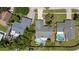 An aerial view showcases the home, pool, landscaping, driveway, and adjacent properties in the neighborhood at 6509 W Longboat Blvd, Tampa, FL 33615