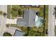 Aerial view of home with an in-ground pool, fenced backyard, driveway, landscaping and mature trees at 6509 W Longboat Blvd, Tampa, FL 33615
