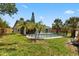 Spacious backyard with pool, mature trees, and privacy fence at 6509 W Longboat Blvd, Tampa, FL 33615