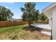 Shot of the backyard and perimeter fencing with a mature shade tree at 6509 W Longboat Blvd, Tampa, FL 33615