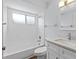 Bright bathroom featuring a shower-tub combination, modern toilet, and sleek vanity at 6509 W Longboat Blvd, Tampa, FL 33615