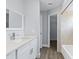 Bathroom featuring a sleek vanity, modern faucet, and tiled shower-tub combination at 6509 W Longboat Blvd, Tampa, FL 33615