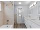 Modern bathroom with double vanity, updated fixtures, and a shower-tub combo at 6509 W Longboat Blvd, Tampa, FL 33615