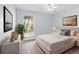 Light and airy bedroom with a large window, neutral decor, and stylish furnishings at 6509 W Longboat Blvd, Tampa, FL 33615