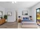 Comfortable bedroom with a large bed, wood floors, and a sliding glass door to the outdoors at 6509 W Longboat Blvd, Tampa, FL 33615