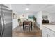 Dining area with modern table and chairs, beautiful artwork, and great lighting at 6509 W Longboat Blvd, Tampa, FL 33615