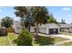 A view of the home's exterior with palm trees and driveway at 6509 W Longboat Blvd, Tampa, FL 33615