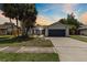 Charming single-Gathering home with a well-maintained lawn, complemented by mature trees and a two-car garage at 6509 W Longboat Blvd, Tampa, FL 33615