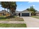 This image showcases the home's well-kept lawn and traditional design at 6509 W Longboat Blvd, Tampa, FL 33615