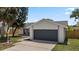 This exterior shot features the home's front-facing garage and landscaping at 6509 W Longboat Blvd, Tampa, FL 33615