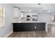 Modern white kitchen with stainless steel appliances and breakfast bar at 6509 W Longboat Blvd, Tampa, FL 33615