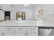 Bright kitchen with a large quartz island, white cabinets, and stainless steel appliances at 6509 W Longboat Blvd, Tampa, FL 33615