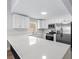 Modern white kitchen with stainless steel appliances and a bright, open layout at 6509 W Longboat Blvd, Tampa, FL 33615