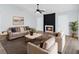 Bright living room featuring modern decor, a cozy fireplace, plush seating, and neutral walls at 6509 W Longboat Blvd, Tampa, FL 33615