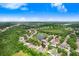 An aerial view of the neighborhood showing the layout of homes, lush greenery, and nearby pond at 6801 Summer Cove Dr, Riverview, FL 33578