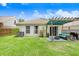 The backyard features a small patio area with comfortable outdoor seating and well-maintained landscaping at 6801 Summer Cove Dr, Riverview, FL 33578
