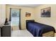 Small bedroom with a large window and natural light, and a dresser and art at 6801 Summer Cove Dr, Riverview, FL 33578