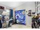 Well lit bedroom with unique artwork, shelves, and a curtain with unique pattern for visual interest at 6801 Summer Cove Dr, Riverview, FL 33578