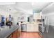Bright, open kitchen featuring white cabinets, stainless steel appliances, a breakfast bar, and modern backsplash at 6801 Summer Cove Dr, Riverview, FL 33578