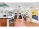 Spacious open-concept living room with hardwood floors, large windows, and a view of a bedroom for versatile use at 6801 Summer Cove Dr, Riverview, FL 33578