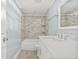 Updated bathroom showcasing a modern vanity, spacious shower-tub combo, and sleek fixtures at 6807 River Rd, Tampa, FL 33615