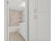Clean bathroom features updated vanity, storage, and bathtub with marble surround at 6807 River Rd, Tampa, FL 33615