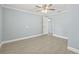 This bedroom has a ceiling fan, neutral paint and new tile flooring throughout at 6807 River Rd, Tampa, FL 33615