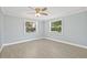 Sunlit bedroom featuring large windows, tile floors, and neutral walls at 6807 River Rd, Tampa, FL 33615