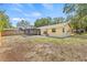 The home's back exterior showing the yard, and the screened-in lanai at 6807 River Rd, Tampa, FL 33615
