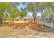 This home features a well maintained lawn and landscaping, complemented by mature trees for a serene setting at 6807 River Rd, Tampa, FL 33615
