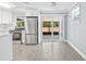Updated kitchen with stainless steel appliances and view to the backyard from the sliding doors at 6807 River Rd, Tampa, FL 33615