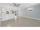 Bright living room with modern flooring, ceiling fan, and an open layout connecting to the kitchen at 6807 River Rd, Tampa, FL 33615