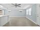Spacious living area with abundant natural light, neutral paint, and modern ceiling fan, perfect for entertaining at 6807 River Rd, Tampa, FL 33615