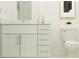 Bright bathroom with a white vanity, granite countertop, and modern fixtures at 7758 Painted Sky Pl, Land O Lakes, FL 34637