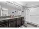 Bathroom featuring a double vanity, granite counters, and a walk-in shower at 7916 Evergreen Creek Ct, Riverview, FL 33578