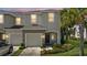 Charming two-story townhouse with a one-car garage and tropical landscaping at 7916 Evergreen Creek Ct, Riverview, FL 33578